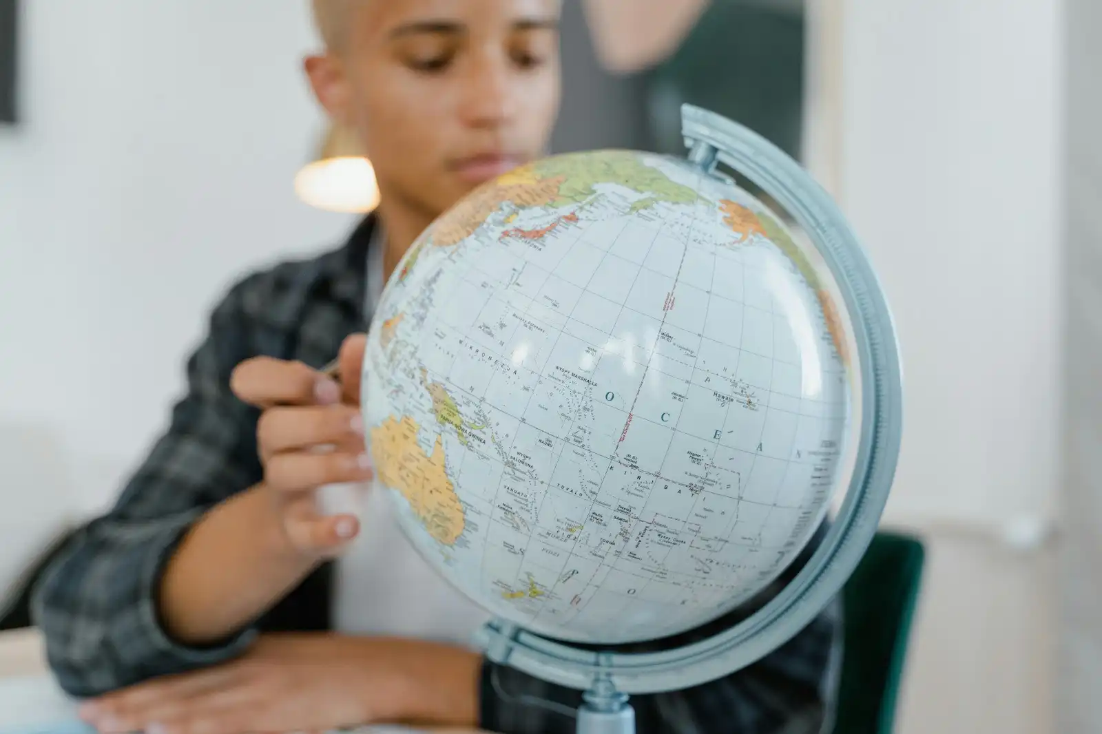 a university student looking at a globe and deciding where the best study abroad options are in the world and which country can provide the best career prospects for graduates from asia